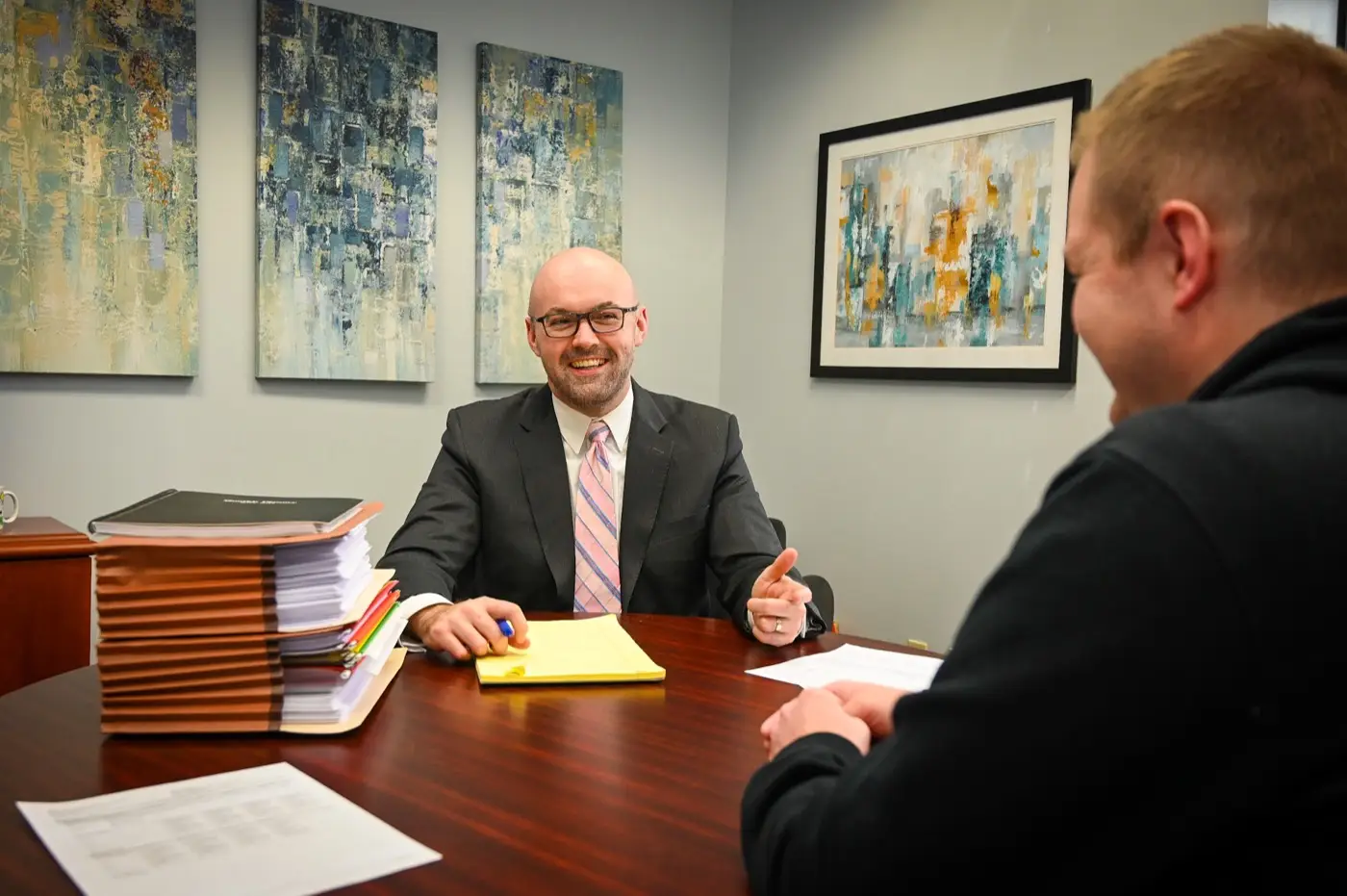 Paul M. Marriett meeting one-on-one with a client at his desk